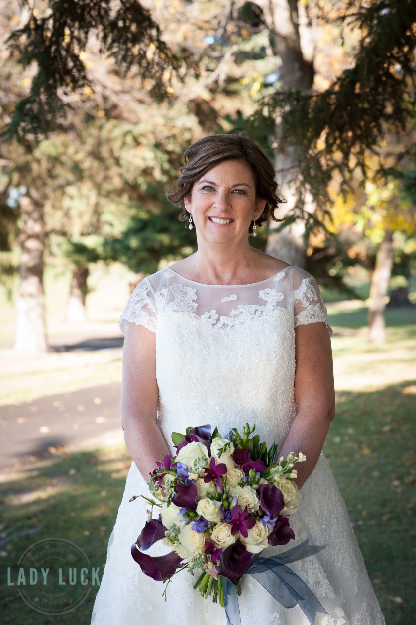 the-bride-holding-her-bouquet-smiling-at-the-camera